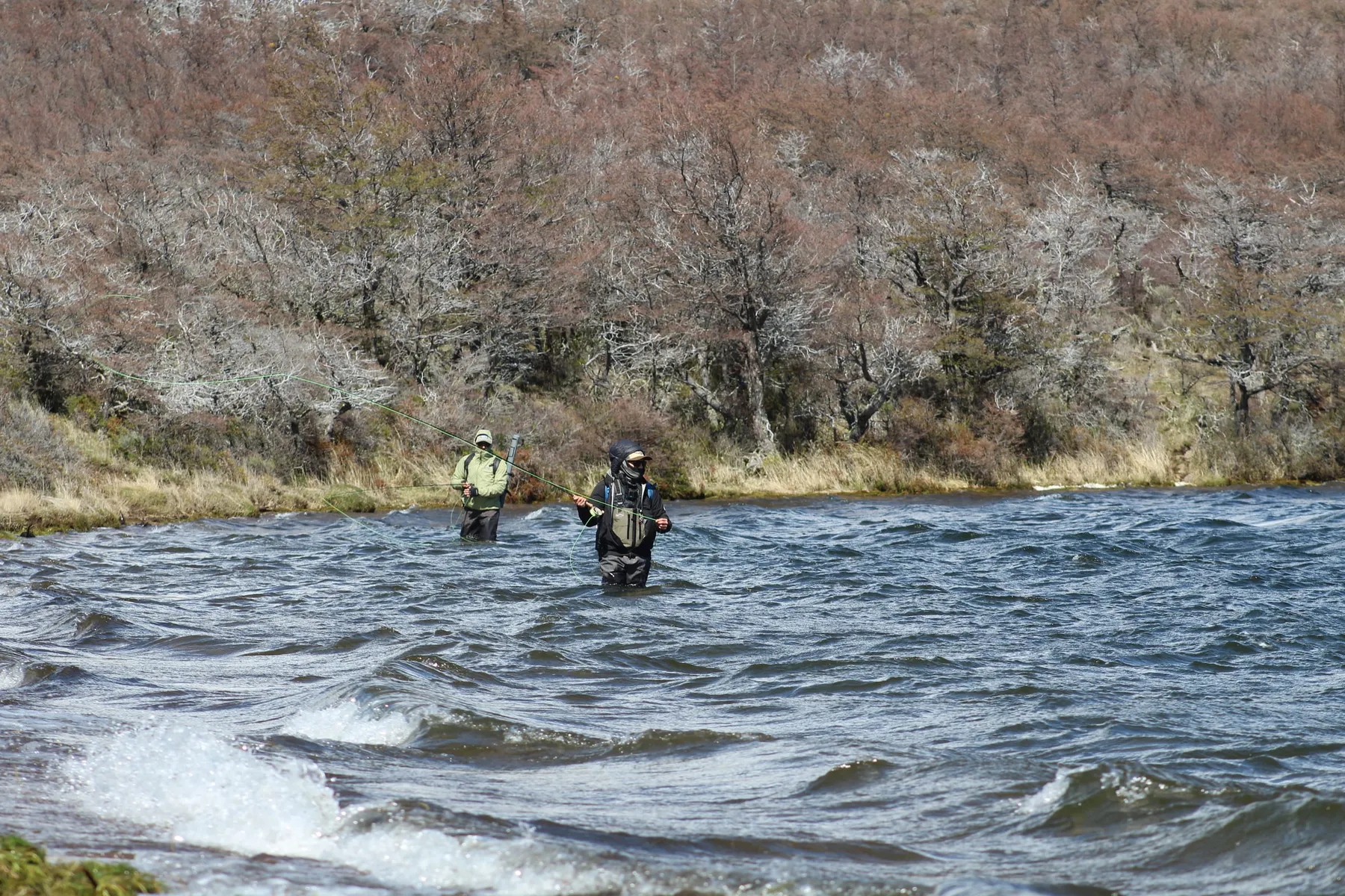 Two anglers fly fishing on a windswept lake in Chilean Patagonia